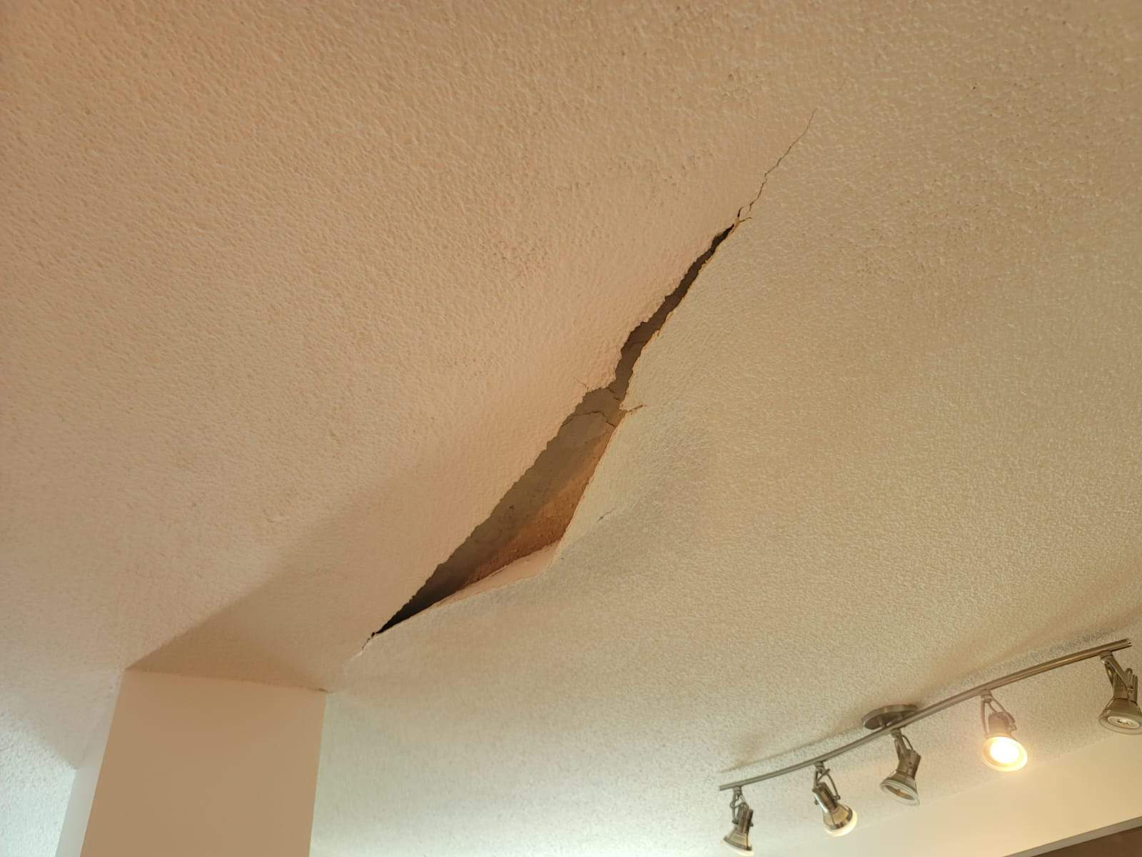Cracked water-damaged ceiling before repair — emergency restoration services GTA