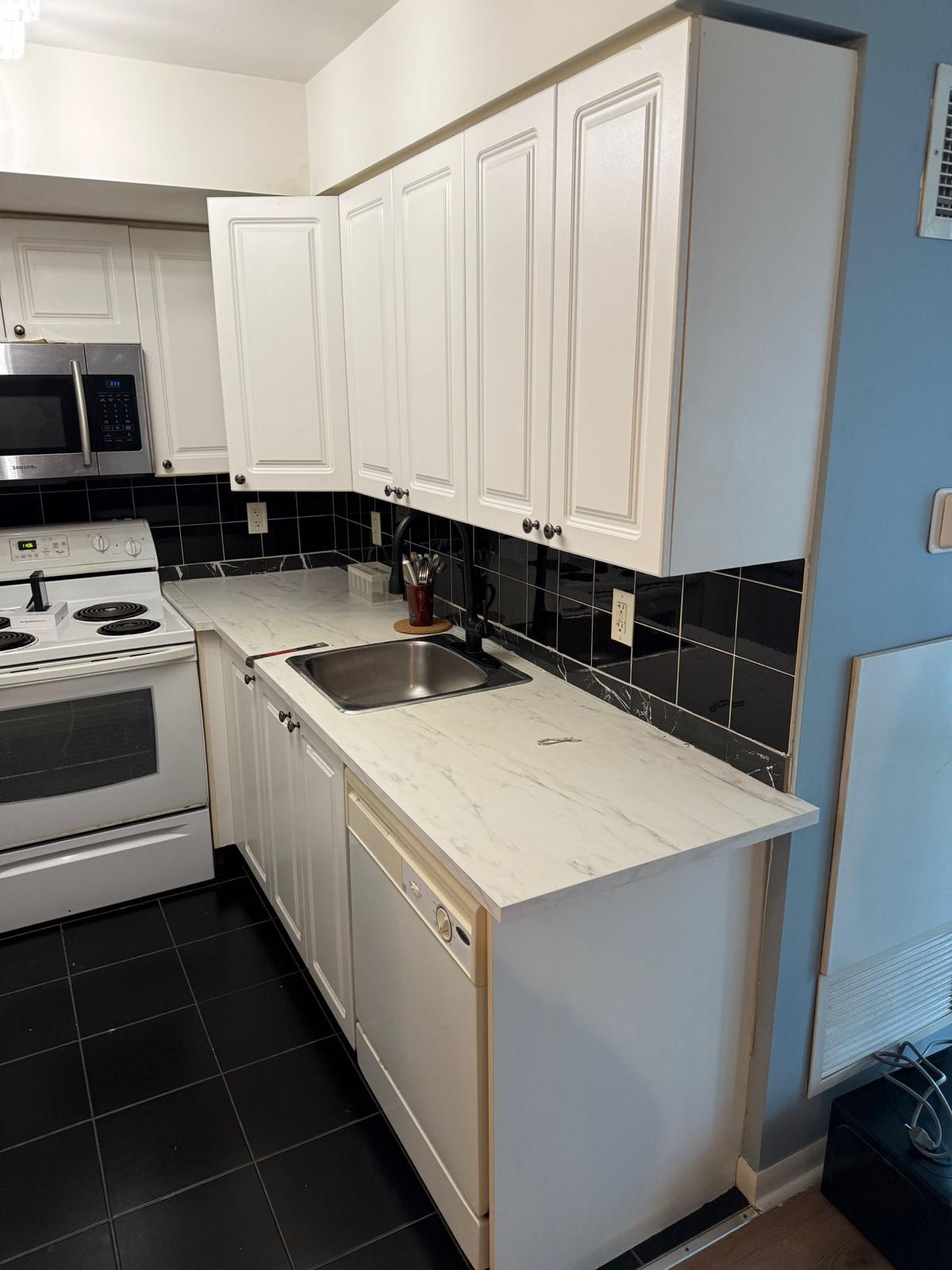 Finished kitchen with new cabinets and countertop — condo repair services GTA