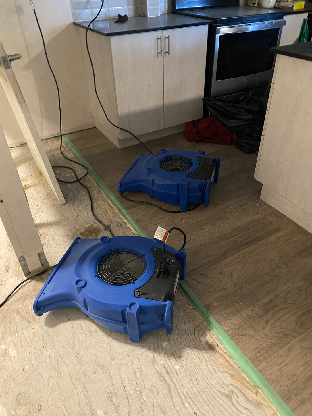 Air movers deployed in kitchen after water damage — emergency restoration GTA